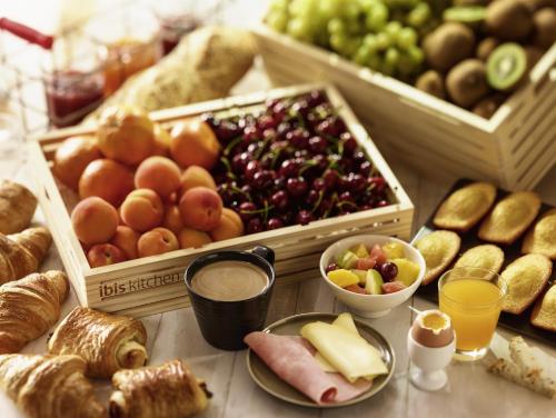a table topped with lots of different types of food at ibis Le Mans Est Pontlieue in Le Mans