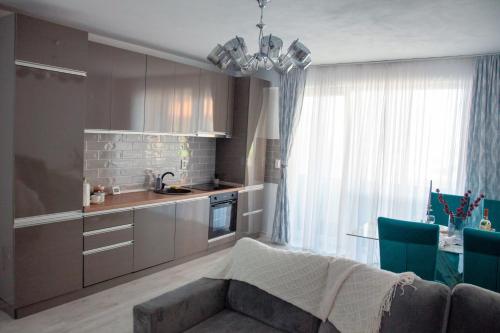 a kitchen with a couch and a table in a room at Noah Residence in Alba Iulia