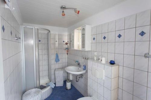 a bathroom with a sink and a toilet and a shower at Ferienwohnung Locke in Kluis