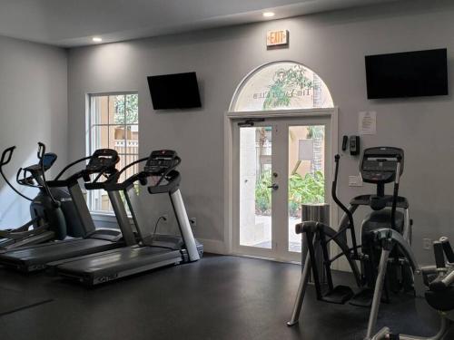 a fitness room with cardio machines and a window at Pet-Friendly Aventura Pool, Beach, Golf, Gym in Aventura