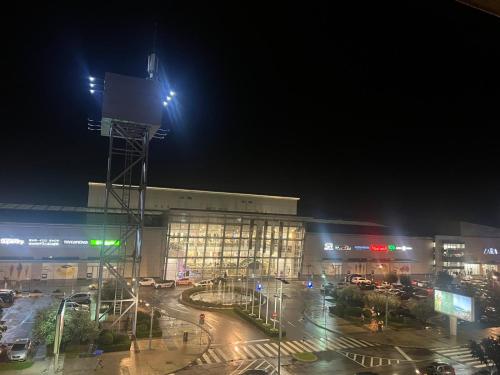 a large building at night with a street in front at Apartment City Kvart Podgorica in Podgorica