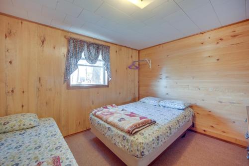 a bedroom with two beds and a window at Stone Lake Cabin with Private Deck and Fire Pit! in Northwoods Beach