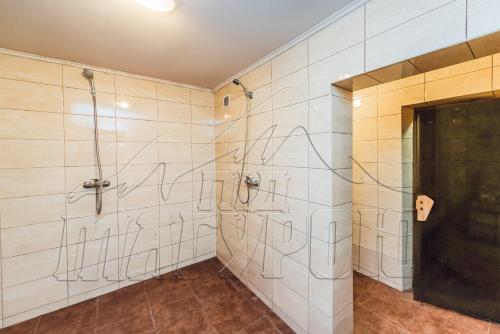 a bathroom with graffiti written on the wall at ПІД МАГУРОЮ in Pilipets