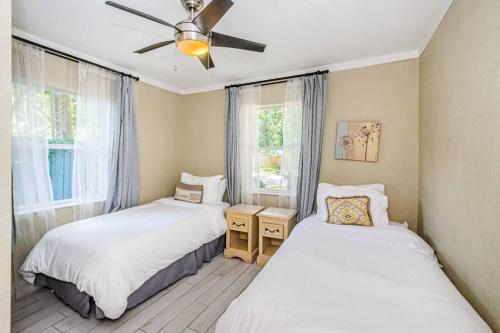 a bedroom with two beds and a ceiling fan at Beautiful Pool House in Old Seminole Heights! in Tampa