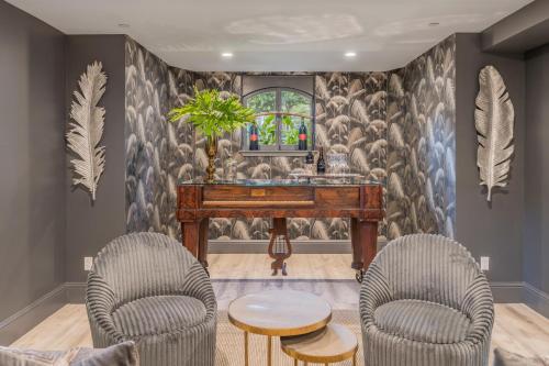 a room with a piano and two chairs and a table at The George - Luxury Boutique Inn in Napa