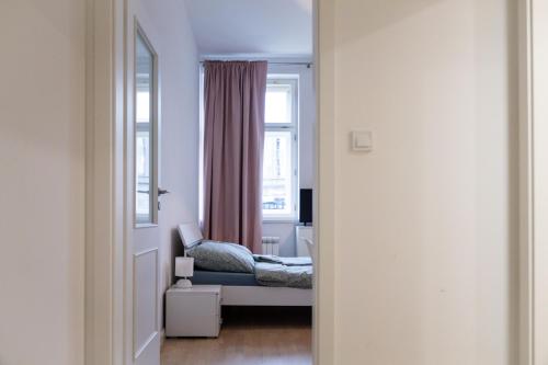 a bedroom with a bed and a window at Washington Apartment in Prague