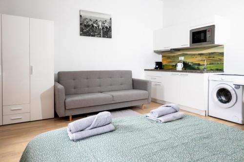 a living room with a couch and a washing machine at Washington Apartment in Prague
