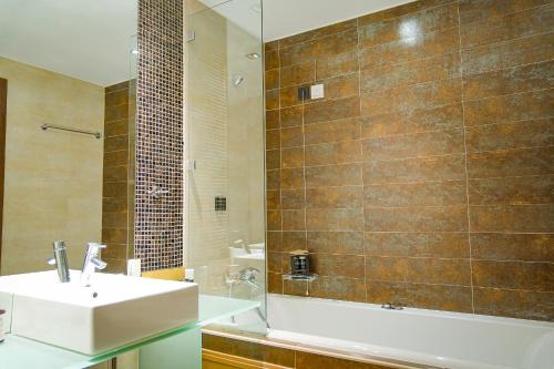 a bathroom with a sink and a shower at Kipi Mountain Resort in Kipoi