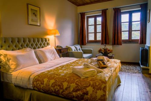 a bedroom with a bed with towels on it at Kipi Mountain Resort in Kipoi