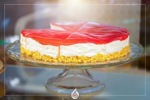 a red and white cake on a glass plate at NBT Hotel Lac in Laç