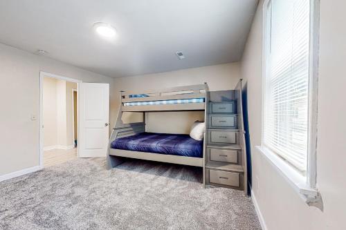 a bedroom with a bunk bed and a window at Easy Keel in Charleston