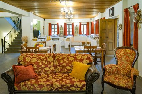 a living room with a couch and a dining room at Kipi Mountain Resort in Kipoi
