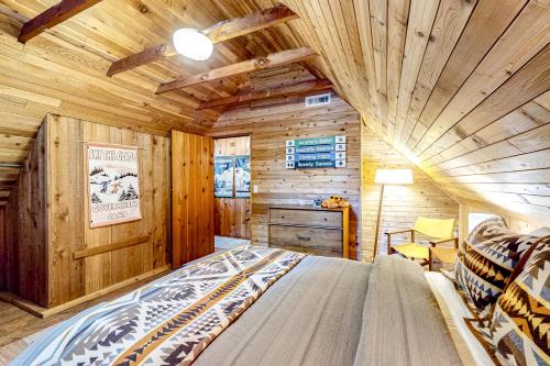 a bedroom with a bed in a wooden cabin at The Cozy Govy Cabin in Government Camp