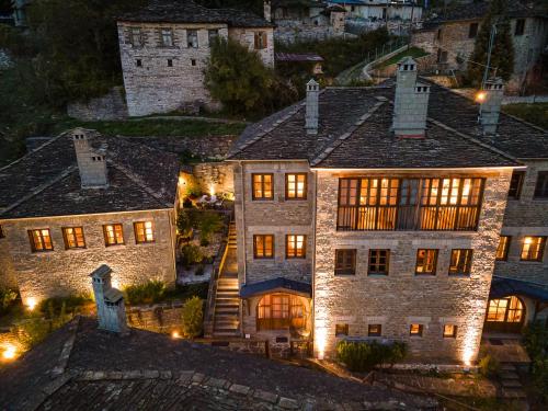 an aerial view of a large stone house at night at Kipi Mountain Resort in Kipoi