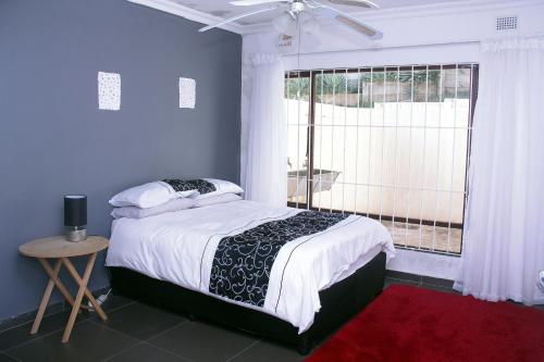 a bedroom with a large bed and a window at 31 Miramar Cove in Port Edward