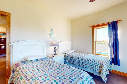 a bedroom with two beds and a window at Mermaid's Lair in Salvo
