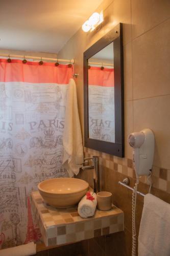 a bathroom with a wooden sink and a mirror at Mirador Serrano in Merlo