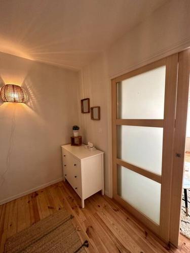 a room with a door and a table with a lamp at Le Studio 41 in Caen