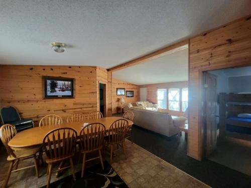 a dining room and living room with a table and chairs at HTR Black Hills Resort in Rockerville