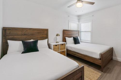 a bedroom with two beds and a ceiling fan at Beachside Oasis in Seal Beach