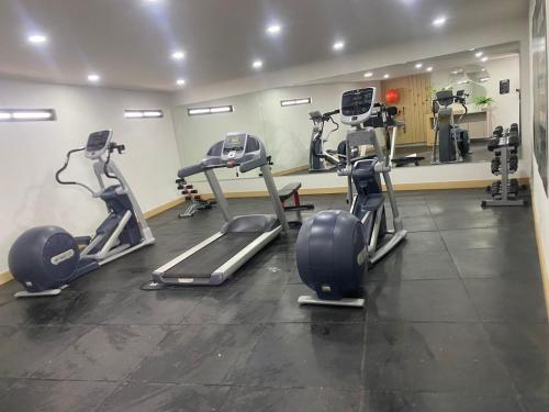 a gym with several tread machines in a room at Loft Platino in Pachuca de Soto