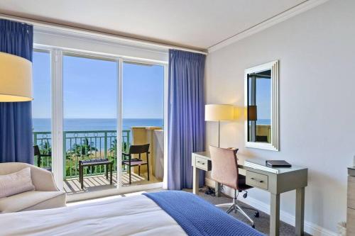 マイアミにあるStudio Located at The Ritz Carlton Key Biscayne, Miamiのベッド、デスク、窓が備わるホテルルームです。