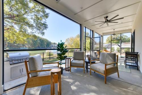 a living room with a large window and chairs at The Retreat at Lake Norman Boat Dock and Pool! in Mooresville
