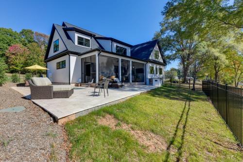 a black and white house with a patio at The Retreat at Lake Norman Boat Dock and Pool! in Mooresville