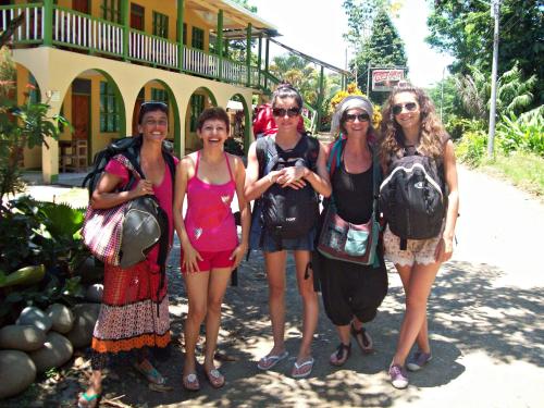 a group of women standing in front of a building at Cabinas Manzanillo Caribe in Manzanillo