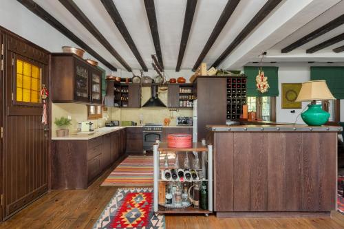 a large kitchen with wooden cabinets and green walls at Villa Papis Metsovo in Metsovo