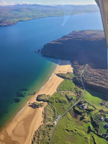 an aerial view of a beach and the ocean at Glenwood guesthouse near Ballybofey in Killygordon