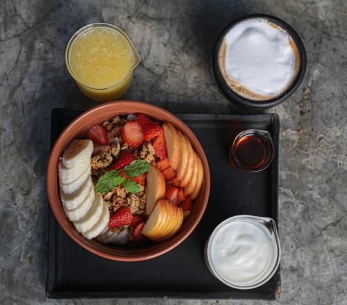a bowl of fruit and a bowl of yogurt at Botånica Tulum in Tulum