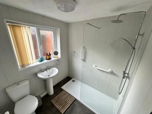 a bathroom with a shower and a toilet and a sink at 4 bed 3 bedroom home near Middlesbrough centre in Middlesbrough