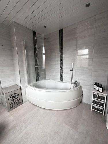 a large bathroom with a large tub in a room at Spacious Modern Duplex Apartment in Rochdale