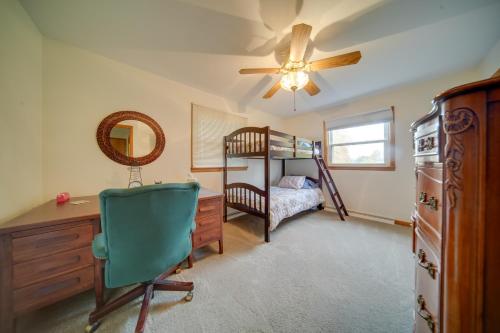 a bedroom with a bunk bed and a desk and a chair at Cozy Ripley Apartment - 21 Mi to Downtown Erie! in North East