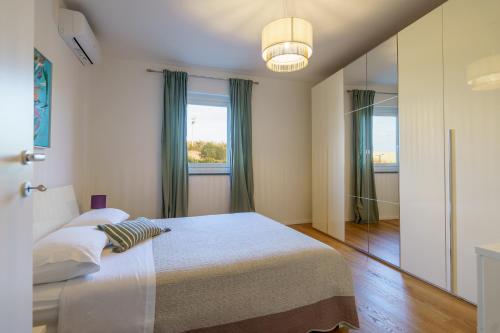 a bedroom with a bed and a large window at La casina dei Praticelli in Castelfiorentino