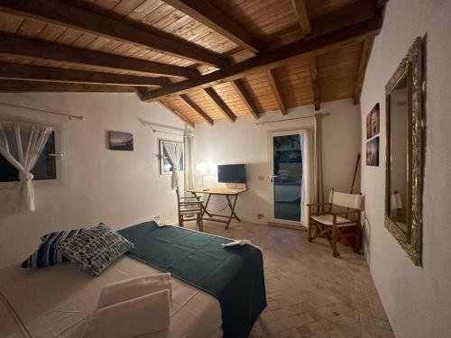 a bedroom with a bed and a table in a room at Residenza ammiraglio Filippo in Varigotti