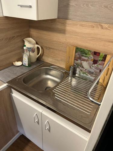 a small kitchen with a sink and a counter at Résidence Sainte Thérèse - la villa Selva in Lourdes