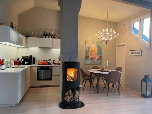 a kitchen with a stove in the middle of a room at Exclusive, cosy, elegant Frogner apartment in the center of Oslo in Oslo