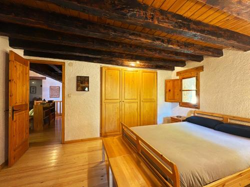 a bedroom with a large bed in a room at Molí de Dalt in La Coma i la Pedra