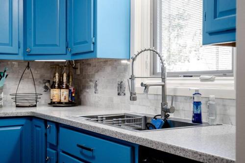 a kitchen with blue cabinets and a sink at My Happy Place-Games, Lakeside, & Scenery Views in Hot Springs