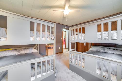 two bunk beds in a room with a ceiling at Houghton Lake Vacation Rental - Walk to the Water! in Houghton Lake