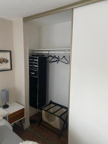 a bedroom with a closet with a door open at Work and Gym Hideaway in San Jose