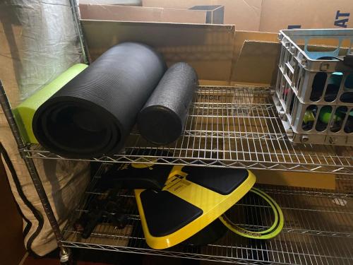 a shelf with two rolls of thread and a yellow tool at Work and Gym Hideaway in San Jose