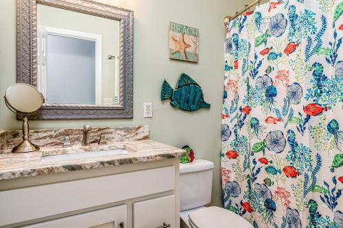 a bathroom with a toilet and a shower curtain at Dauphin Island Beach Club 106A in Dauphin Island