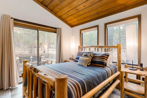 a bedroom with a bed and a large window at Jackalope Manor in Sunriver