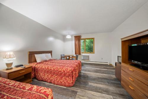 Ένα ή περισσότερα κρεβάτια σε δωμάτιο στο Executive Inn