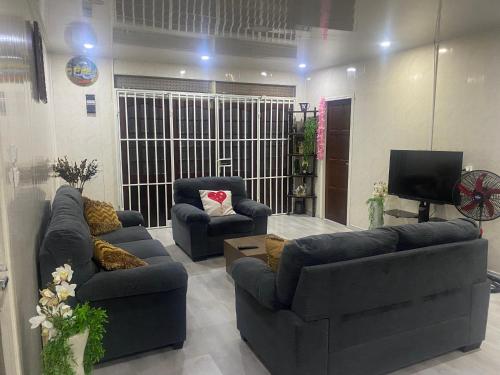 a living room with two couches and a television at City Appartementen New Nickerie - 4-6p in Nieuw Nickerie