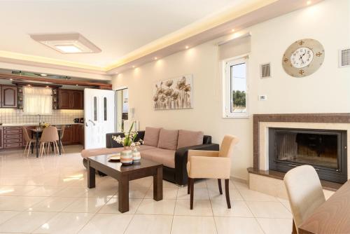 a living room with a couch and a fireplace at Amarlia Villa in Skaleta