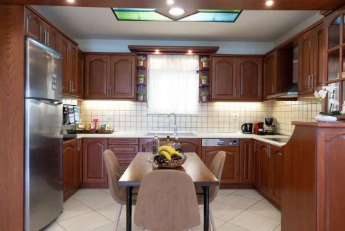 a kitchen with a table with a bowl of bananas on it at Amarlia Villa in Skaleta